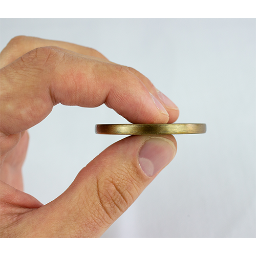 a hand holding Congratulations Graduate Antique Gold Plated Christian Coin sideways