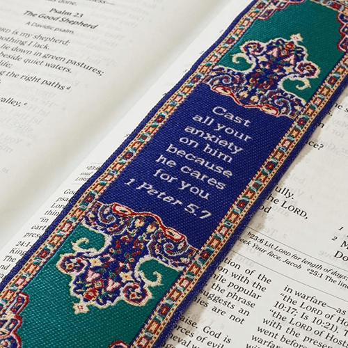 woven tapestry-style bookmark placed on a bible