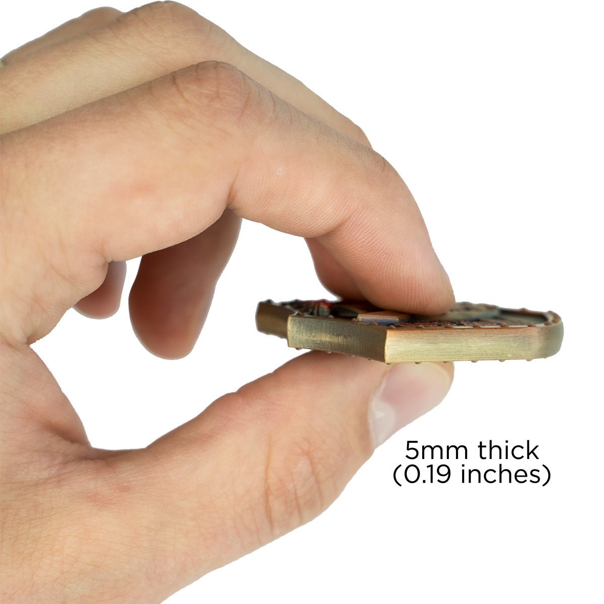 Hand holding Armor of God Shield Challenge Coin to show the thickness of the coin - 5mm thick or 0.19inches