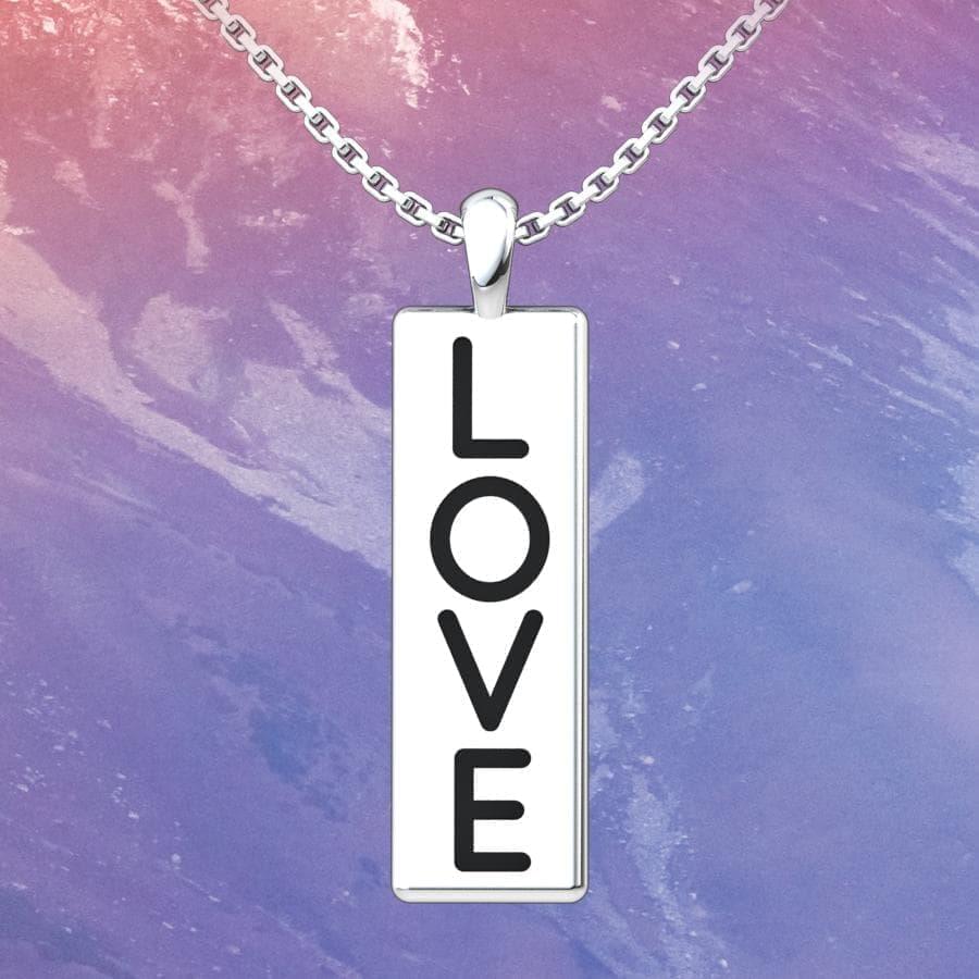 Love Conquers All Sterling Silver Pendant with an 18 inch with a marble background