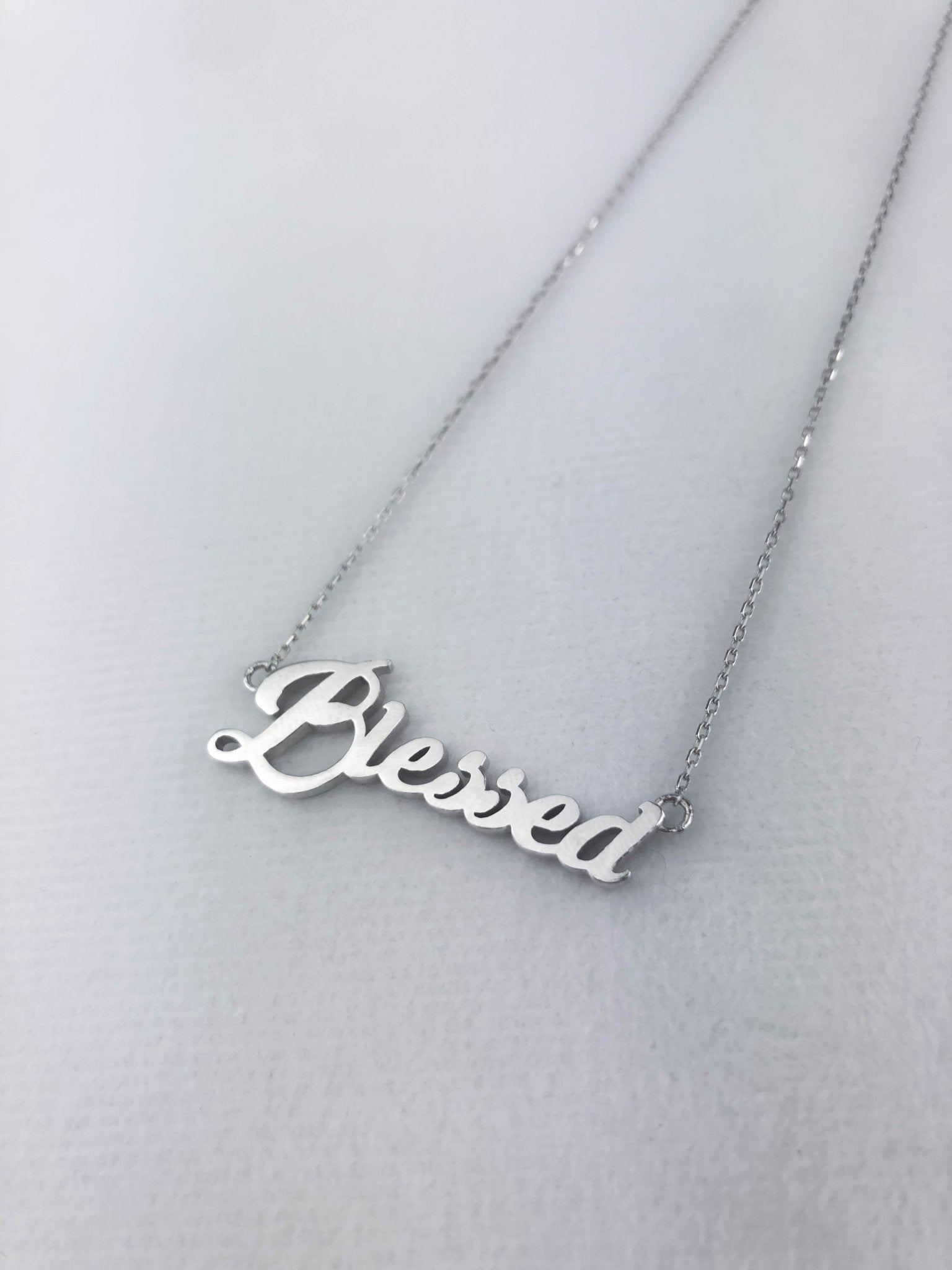 Blessed sterling silver pendent with an 18 inch chain on a white background