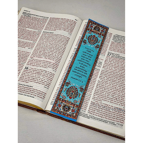 woven tapestry-style bookmark placed on a bible