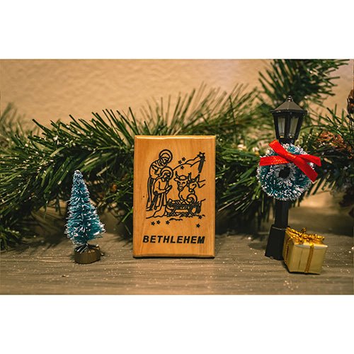 Holy family manger holy land olive wood magnet amid garland and seasonal décor