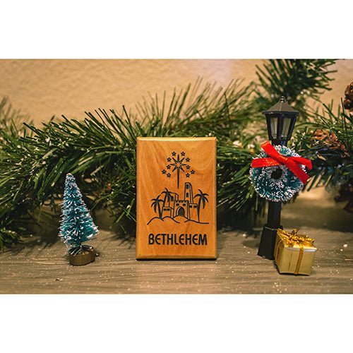 Bethlehem city and christmas star holy land olive wood magnet amid garland and seasonal décor