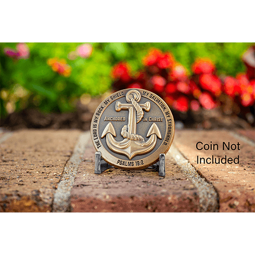 silver challenge coin display with coin in front of flowers