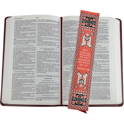 woven tapestry-style bookmark placed on a bible