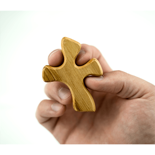 Clinging Healing Comfort Cross, Small, Certified Olive Wood from Israel in hand