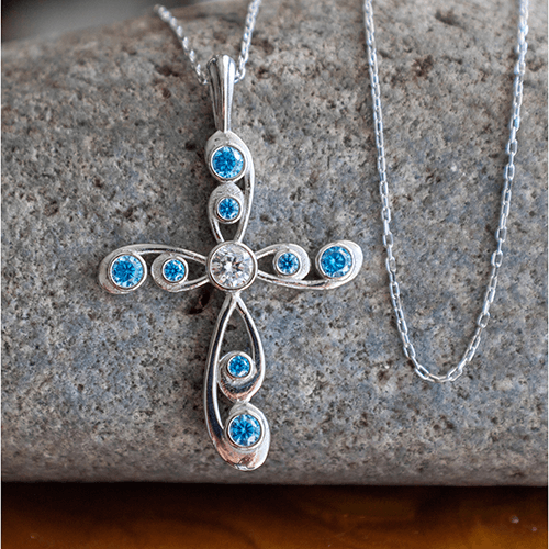 This stunning antique Blue Topaz December Birthstone Cross Pendant merges the old with the new in a modern take on antique styling. 
