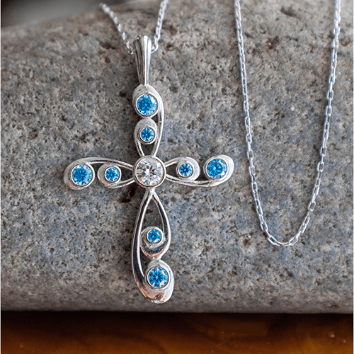 This stunning antique Blue Topaz December Birthstone Cross Pendant merges the old with the new in a modern take on antique styling.