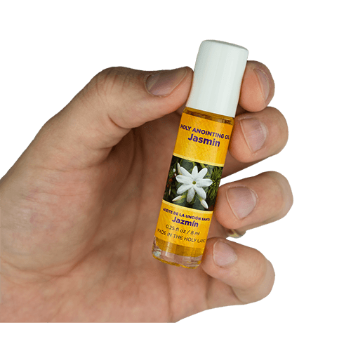 view of jasmin scented anointing oil being held in a human hand