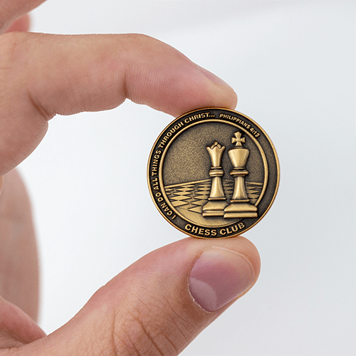 Front of Chess Club Christian Antique Gold Plated School Coin held in between fingers