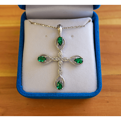 This Antique Emerald May Birthstone Cross Pendant with an 18" sterling silver chain with a spring-ring clasp and is packaged in a luxurious plush velvet box.