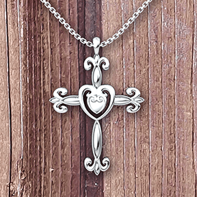 Heart Cross Sterling Silver Necklace with 18 inch chain on a wooden table